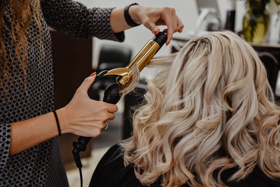Haircare-curls woman getting her hair done at a salon, spa